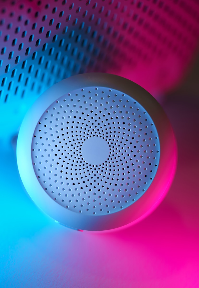 A blue speaker sitting on top of a table